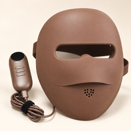 Auva Glow Mask hero shot with one-touch remote on cream travertine pedestal